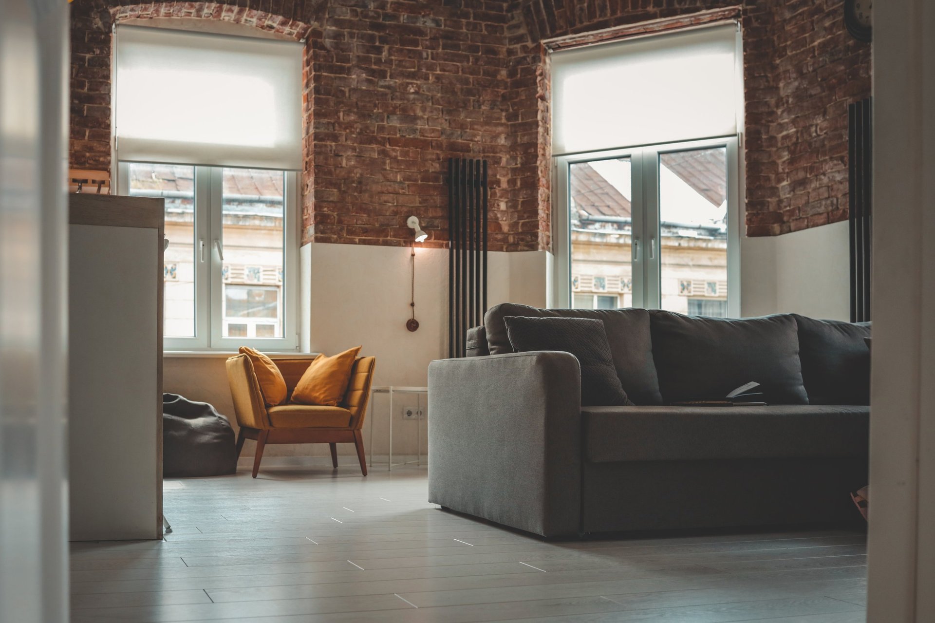 Cozy living room with brick walls and large windows
